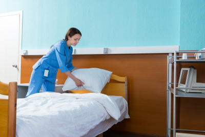 caregiver cleaning senior's room